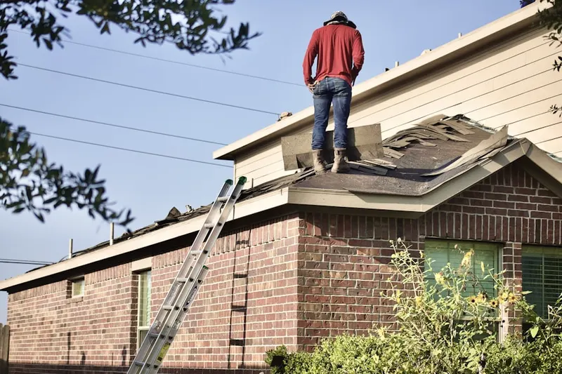 Professional roofer working on a residential roof in Mustang Pointe Aerodrome Condominiums